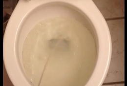 Piss far the toilet after filling a bottle involving piss.